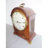 A 19th century mahogany and boxwood-strung eight-day bracket clock; the oval hinged gilt-metal