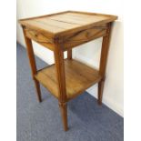 A 19th century French vernacular wooden wine table; the galleried slatted wooden top above a