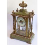 A 19th century banded onyx and champlevé enamel mounted eight-day mantle clock; the central gilt-