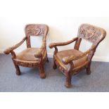 A pair of highly unusual 19th century open-armed, heavy hardwood, low chairs (possibly Malaysian);