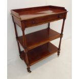 A mid-19th century three-tier mahogany buffet; the three-quarter galleried top above a single full-