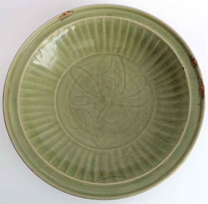 A large early 17th century Chinese Longquan bowl with celadon glaze; the moulded lip above a