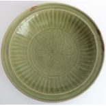 A large early 17th century Chinese Longquan bowl with celadon glaze; the moulded lip above a
