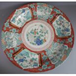 A large 19th century Japanese porcelain charger; the vignettes and decorated with dragons,