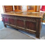 An extremely large late 17th century panelled oak chest.The four-panel hinged top opening to