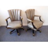A pair of fine teal-leather-upholstered swivel armchairs; the downswept ebonised arms headed with