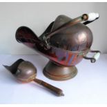 A 19th century helmet-shaped copper coal scuttle and scoop