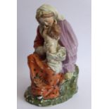 A large early to mid-19th century hand-decorated Staffordshire-style porcelain figure; a seated