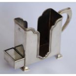 A hallmarked silver rectangular holder with handle; the middle section of 'cut-away' form and having
