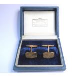 A pair of 9 carat yellow gold tonneau plaque cufflinks with engraved decoration, swivel topedo