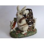 A large, heavy and unusual ceramic model of a standing white rabbit with a young kitten climbing out