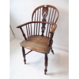 A mid-19th century yew wood Windsor chair; pierced shaped splat, shaped elm seat and turned slightly