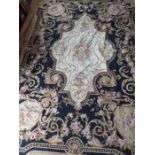 An unlined Aubusson tapestry in a floral geometric pattern in black and beige with a central