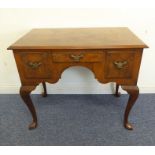 An early 20th century walnut veneered lowboy in mid-18th century-style; the quarter veneered,