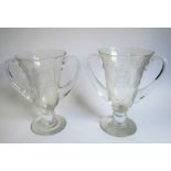 A pair of mid-20th century two-handled clear-glass vases foliates engraved and with the cypher of