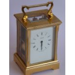 A good modern gilt metal and glass sided carriage clock; the white enamel dial with Roman numerals