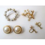 Four items of cultured pearl jewellery; a pair of mabé ear clips, stamped '585'; a floral and