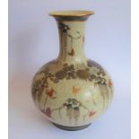 An early 20th century Japanese Satsuma vase of bottle form; hand gilded and decorated with various