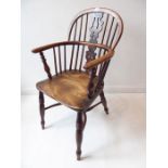 A mid-19th century yew wood Windsor chair; having pierced splat, shaped elm seat and turned legs