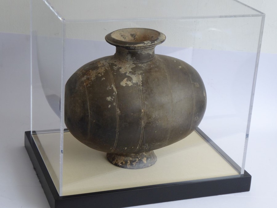 A Chinese Han Dynasty (206 BC - AD 220) incised cocoon jar. Grey, flared circular neck with