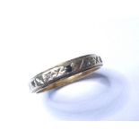 A 9 carat yellow gold band ring, with engraved decoration and alternately set at intervals with