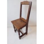 An 18th century North-Country-style oak back stool; moulded boarded seat above turned and block