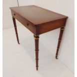 A very fine early 19th century writing table; rosewood and gilt highlighted in the Regency style,