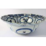 A Kangxi-period Chinese porcelain bowl; hand-decorated in underglaze blue, the interior with four