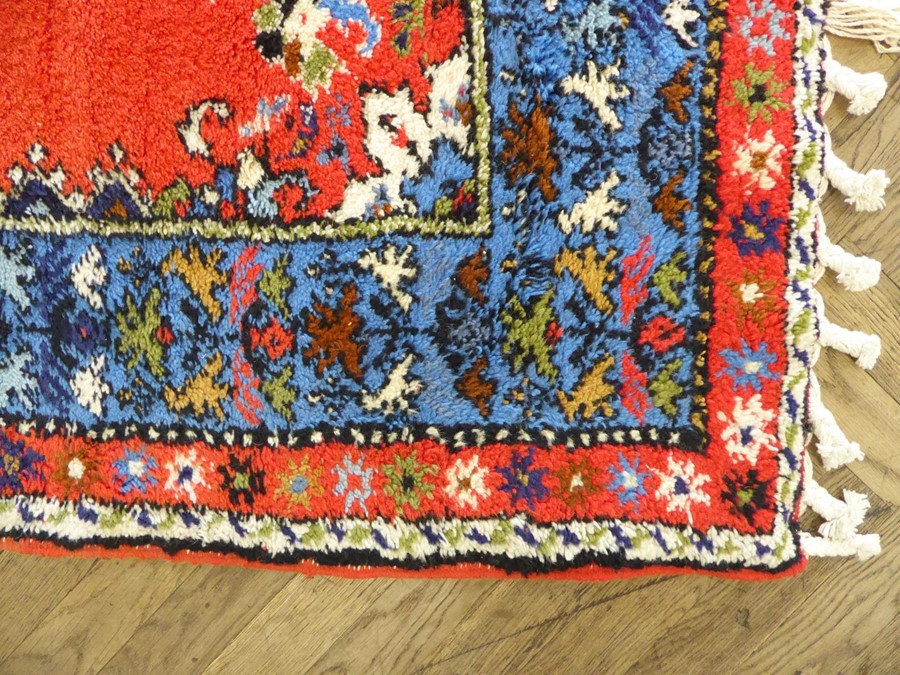 A Moroccan Rabat carpet; central flowerheads against a red ground within blue and red varying - Image 2 of 5