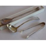 A hallmarked silver ladle, a pair of hallmarked silver sugar tongs and a boxed hallmarked silver