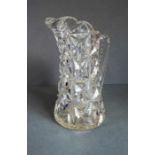 A very heavy hand-cut 19th century crystal jug; with star-cut base and fluted-style cutting to upper