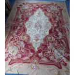 An unlined Aubusson tapestry with a floral geometric pattern in red and cream/gold ornamented with