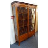 A late 19th/early 20th century Sheraton Revival satinwood display cabinet; the stop fluted cornice