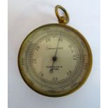 A late 19th/early 20th century handheld travelling barometer; the dial marked 'Compensated' and '