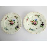 A pair of early 19th century Bloor Derby ceramic plates; each decorated with a central floral