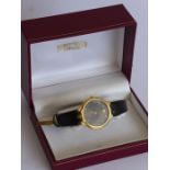 A gentleman's gold cased (hallmarked) Omega dress wristwatch; the signed black dial with baton