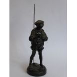 A mid-20th century Russian black-painted ironwork sculpture of a young boy with fishing rod;
