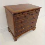 An early 20th century walnut veneered miniature chest in 18th century George III-style; the