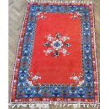 A Moroccan Rabat carpet; central flowerheads against a red ground within blue and red varying
