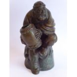 An 18th/19th century well-patinated heavy Chinese bronze; the seated bearded figure with finely cast