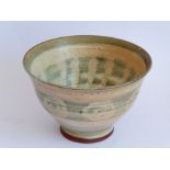An interesting Studio pottery bowl; the slightly flaring lip above a horizontal reeded body