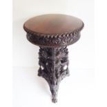 A late 19th/early 20th century Anglo-Indian carved rosewood/hardwood circular work table with rising