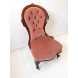 A mid-19th century mahogany and button-back upholstered grandmother / nursing chair; serpentine