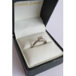A lady's fine 18 carat white gold dress ring; centrally-set with four diamonds within a square