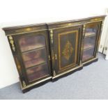 An ebonised breakfront credenza of large proportions; amboyna-banded, marquetry and gilt-metal-