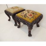 A pair of mid-19th century mahogany stools; floral needlework upholstered drop-in seats above