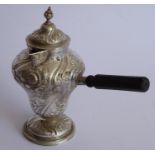 An ornate 19th century hallmarked silver chocolate cup and cover; the hinged top with finial above a