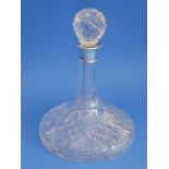 A finely cut crystal ship's decanter with silver-mounted collar; the heavy spherical crystal stopper