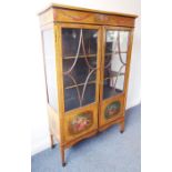 A late 19th / early 20th century Sheraton Revival painted satinwood display cabinet; the frieze
