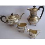 An early 20th century four piece hallmarked silver tea service comprising teapot, two-handled sugar,